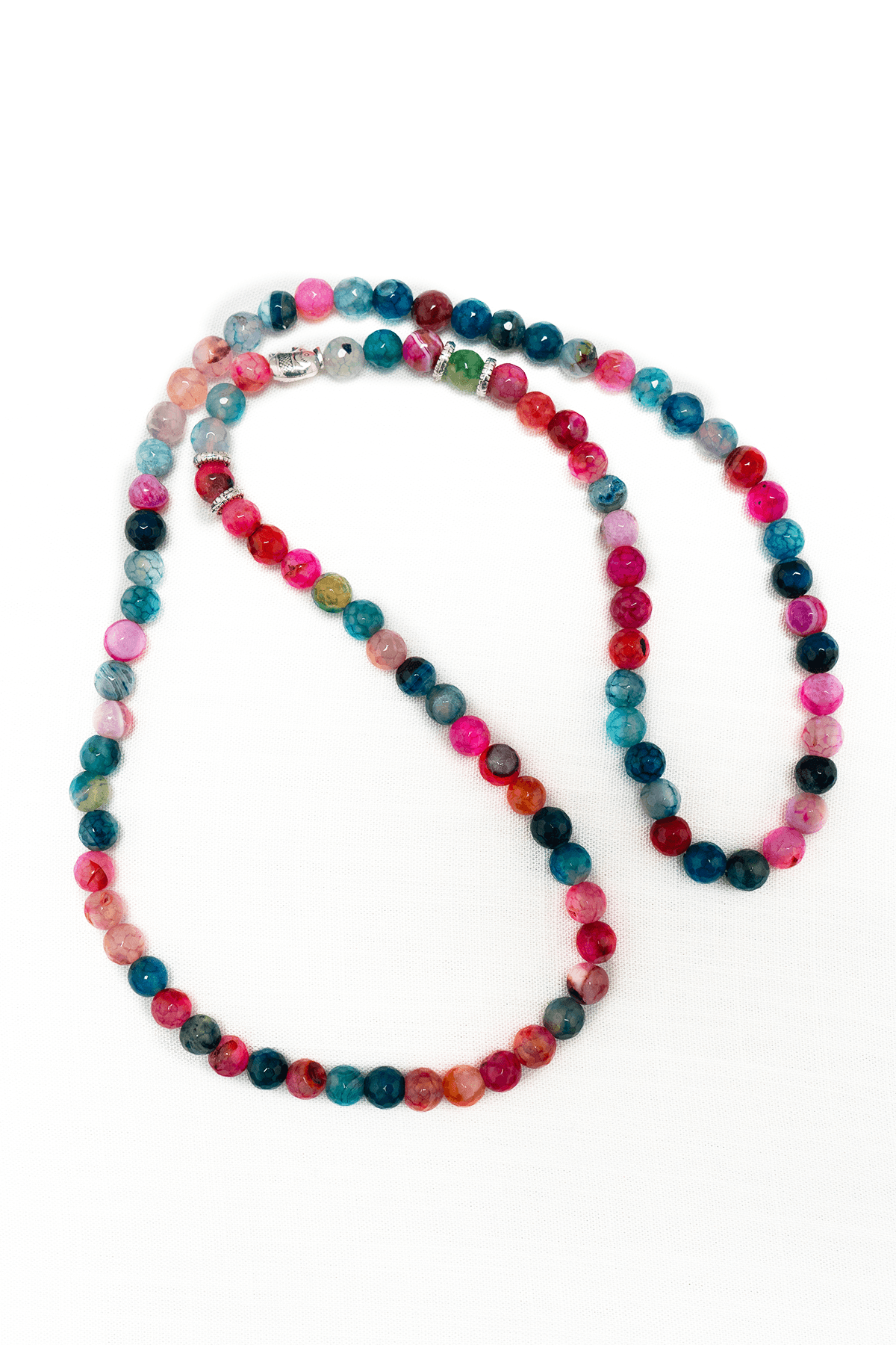 Colorful agate bead necklace with round polished multi-toned stones on white background