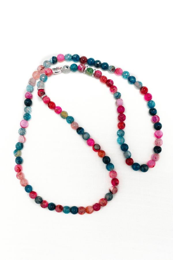 Colorful agate bead necklace with round polished multi-toned stones on white background