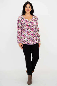 Woman walking in floral sweetheart neckline bamboo top and black pants