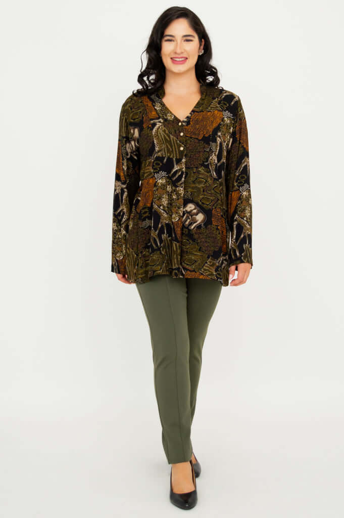 Model walking towards camera in Shirley Batik Art print top and olive trousers