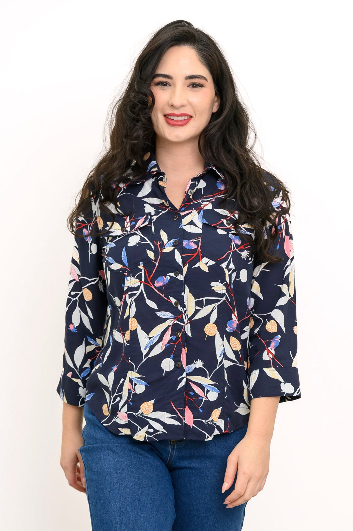 front view of woman wearing navy blue blouse with multicolor floral print on a white background