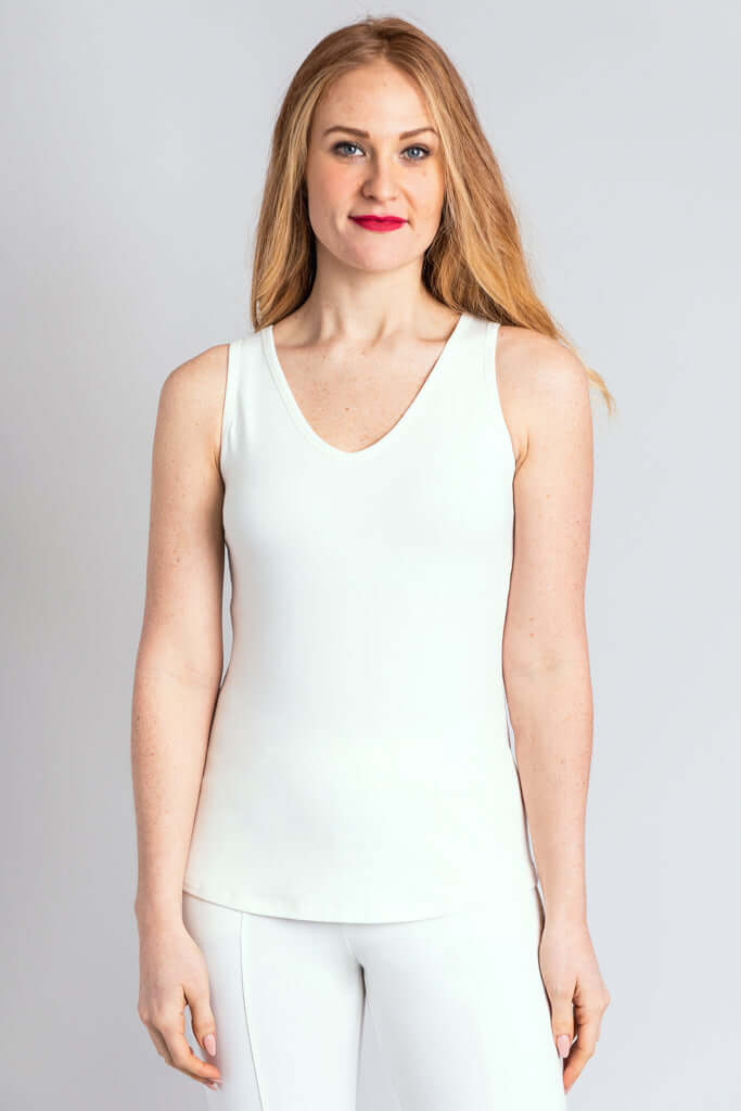 Woman wearing a white bamboo reversible tank with V-neckline, front view