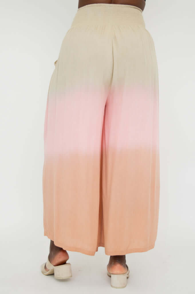 Wide leg ombre pants in beige and peach shown from the back
