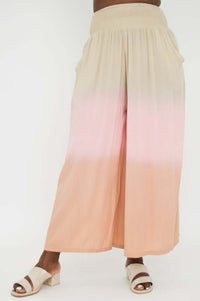 Wide leg ombre pants in beige and peach shown from the front