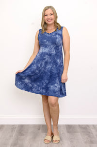 Front view woman wearing sleeveless blue tie dye short dress and sandals on a white background