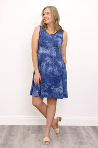 Front view woman wearing sleeveless blue tie dye short dress and sandals on a white background