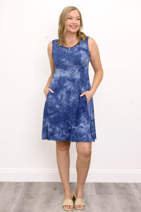 Front view woman wearing sleeveless blue tie dye short dress with pockets on a white background