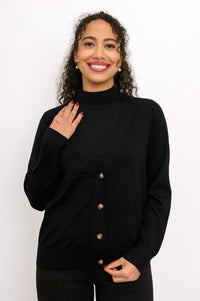 Close up front view of a woman wearing a black 100% merino wool deep v-neck cardigan sweater.