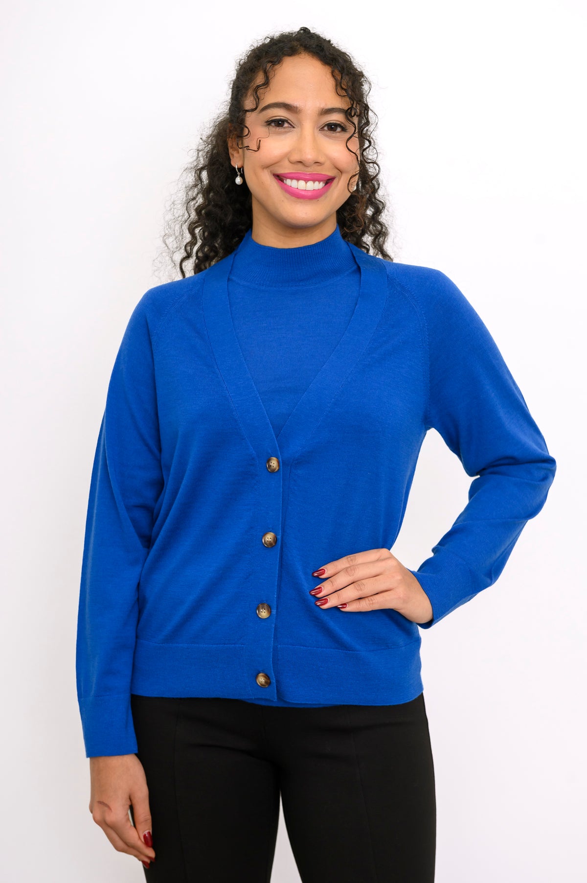 Close up front view of a woman wearing a cobalt blue 100% merino wool deep v-neck cardigan sweater.