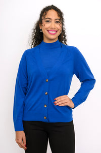 Close up front view of a woman wearing a cobalt blue 100% merino wool deep v-neck cardigan sweater.