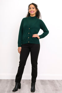 Woman modeling a deep forest green sleeveless knit top layered under a matching green buttoned cardigan.