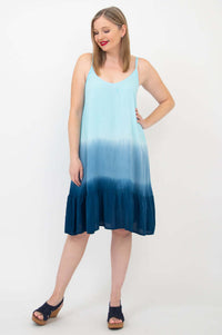 Woman displaying flounce hem ombre aqua sundress with relaxed pose