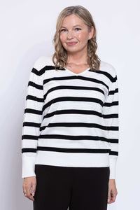 Woman wearing a black and white Breton stripe V-neck sweater viewed from the front