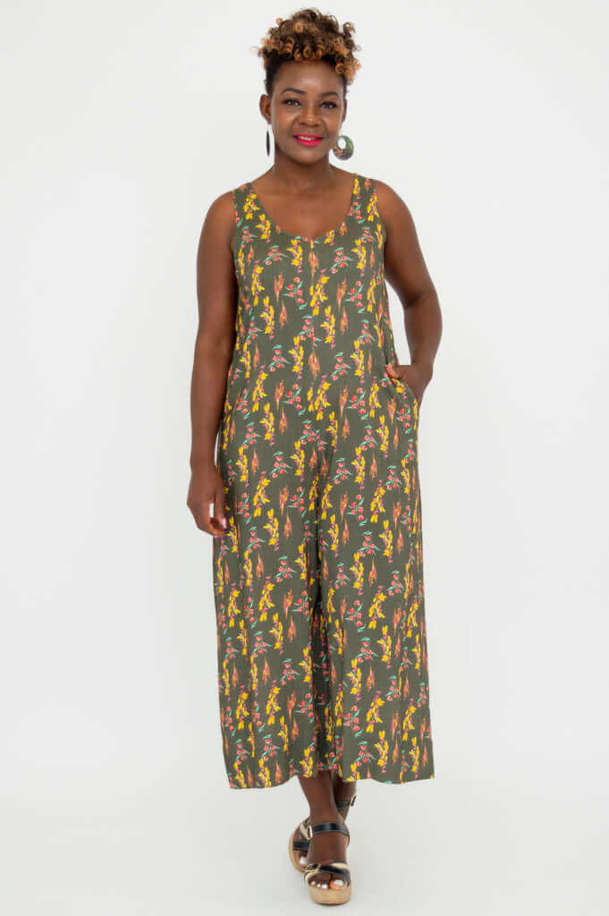 Model standing in a sleeveless floral jumpsuit, hands in pockets