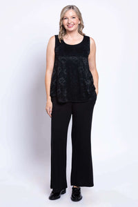 Woman posing wearing black lace overlay tank with wide-leg pants