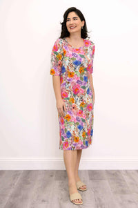 Woman smiling and wearing a floral bamboo dress, angled view
