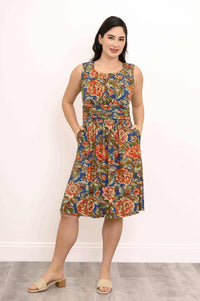 Woman in front view pose, displaying ruched floral dress with pockets