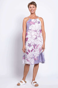 Woman wearing a sleeveless purple and white floral knee-length dress with tie shoulder