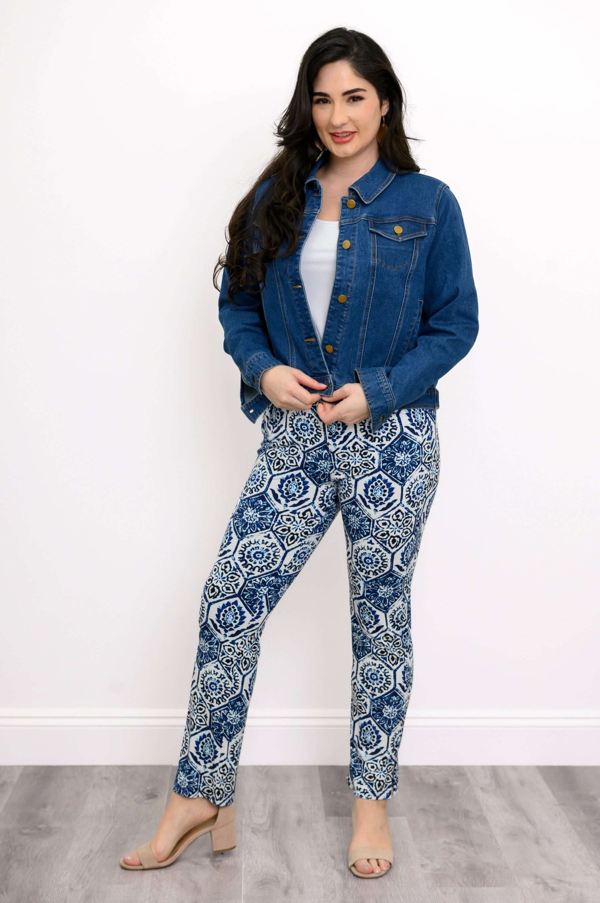 Woman wearing printed blue and white slim fit pants with a denim jacket and heels