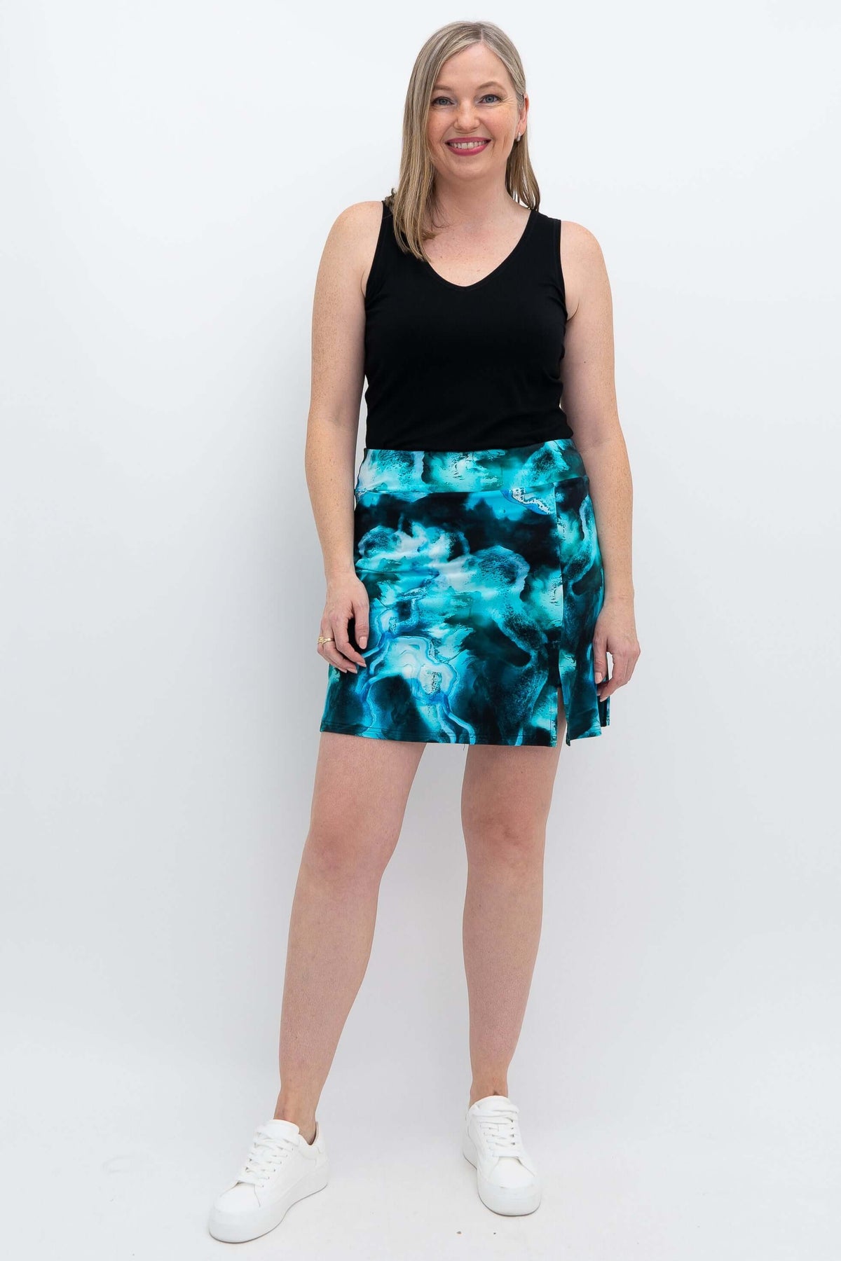 Woman modeling aqua marble Melly skirt-shorts with black tank top