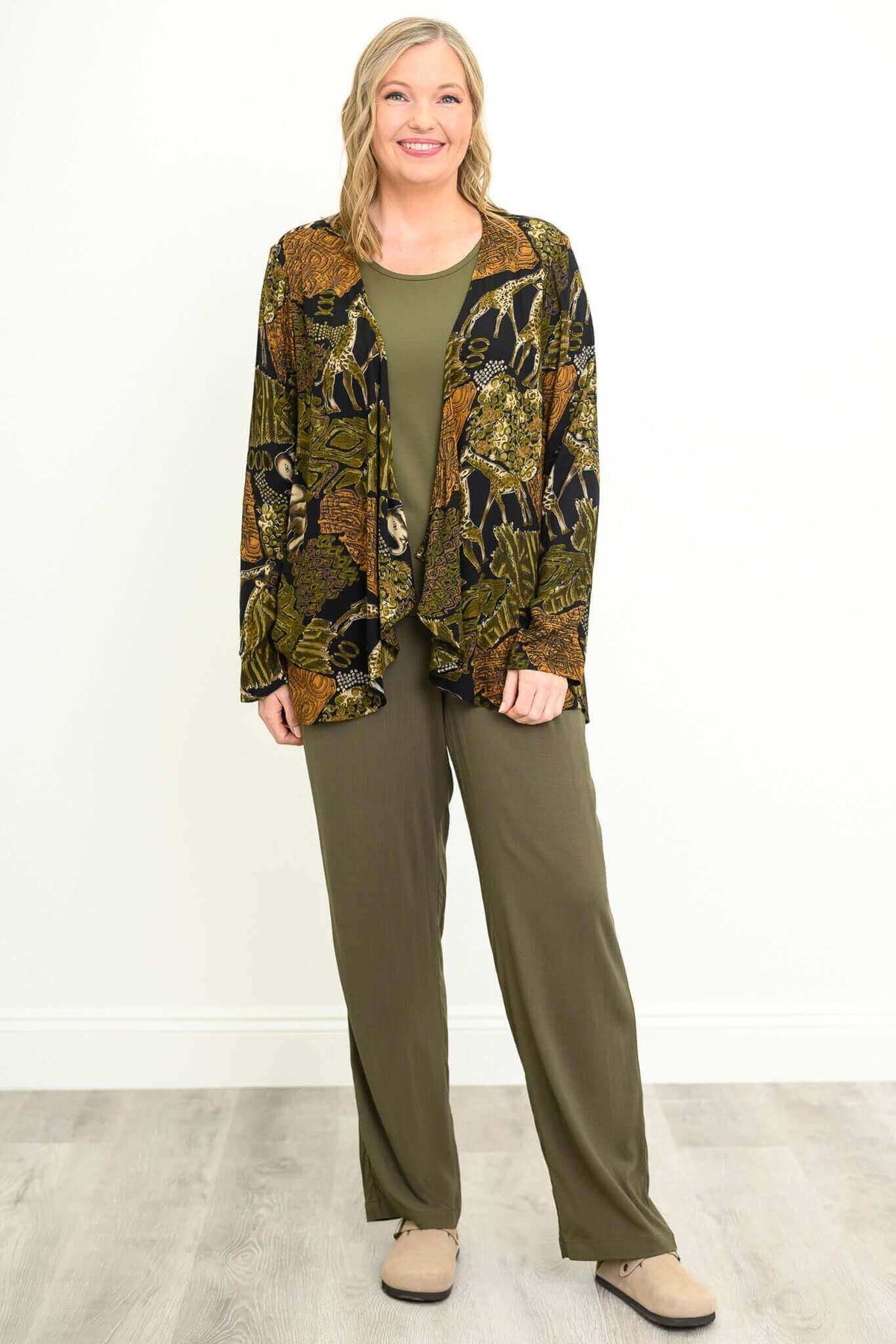 Woman wearing olive bamboo linen pants styled with patterned jacket