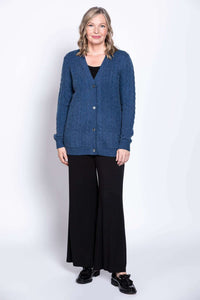 Woman modeling blue cable knit cardigan, full length