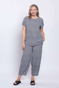 Woman standing in gingham linen blend tee and matching pants on white background