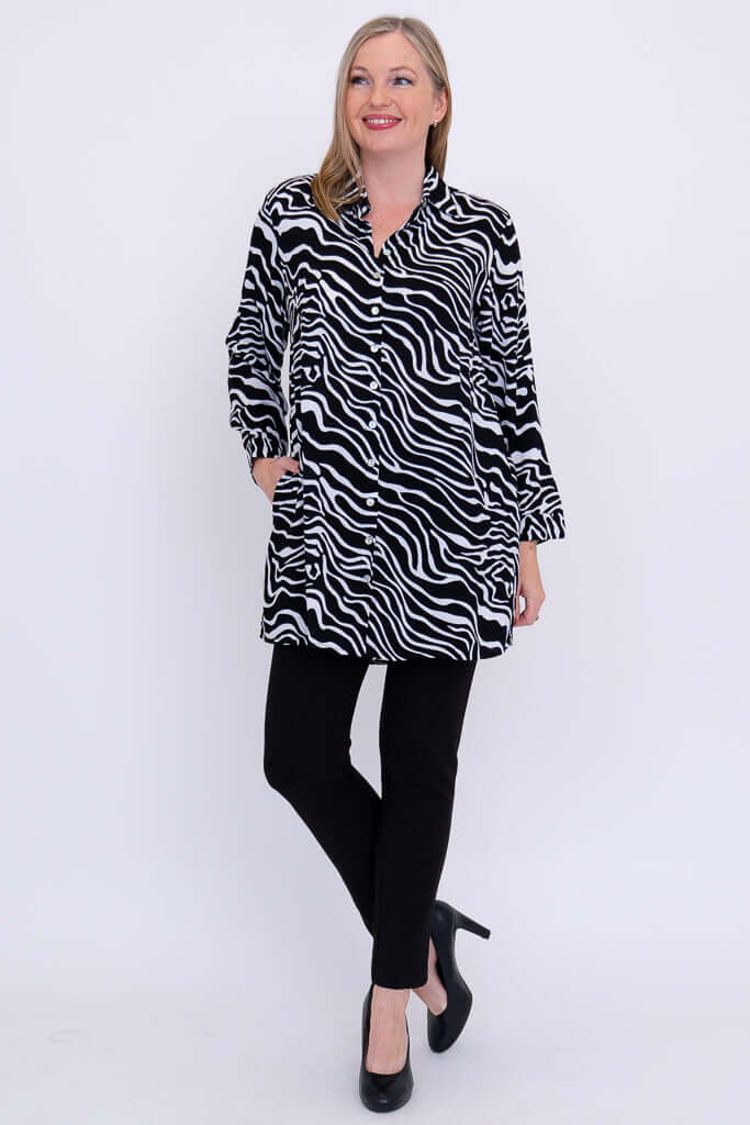Woman posing in black and white zebra batik tunic shirt and black pants
