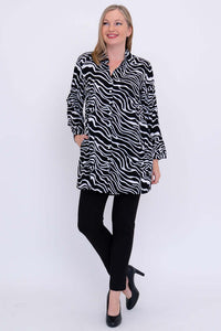 Woman posing in black and white zebra batik tunic shirt and black pants