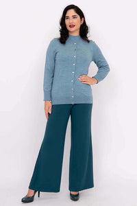 Woman posing in blue Kitten Cardigan buttoned up with teal wide-leg pants