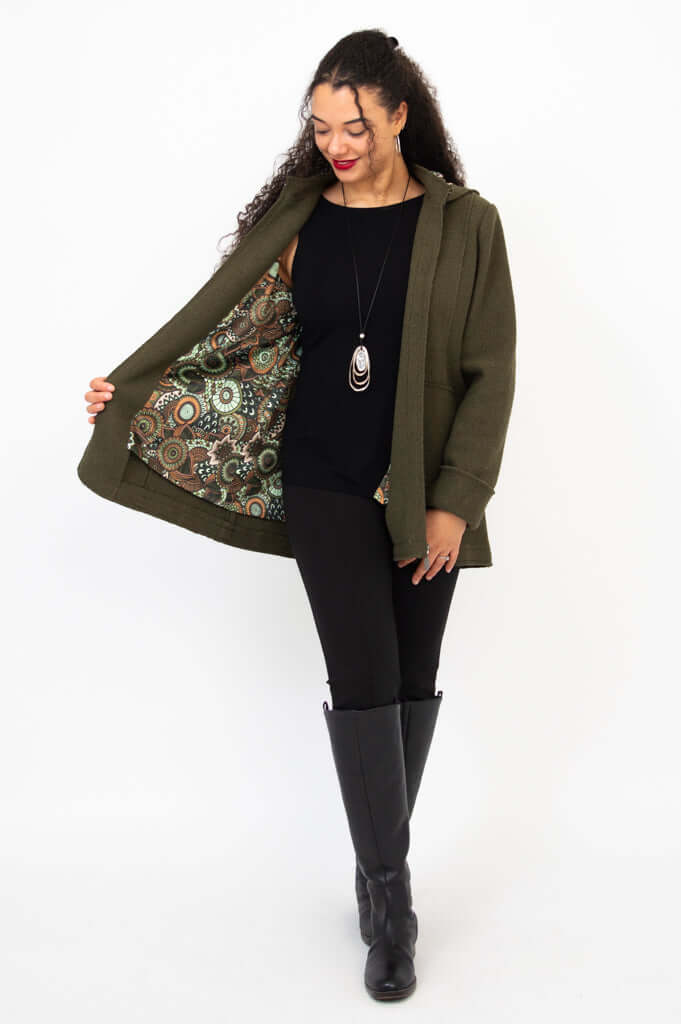 Woman showing the patterned lining inside olive green wool blend coat