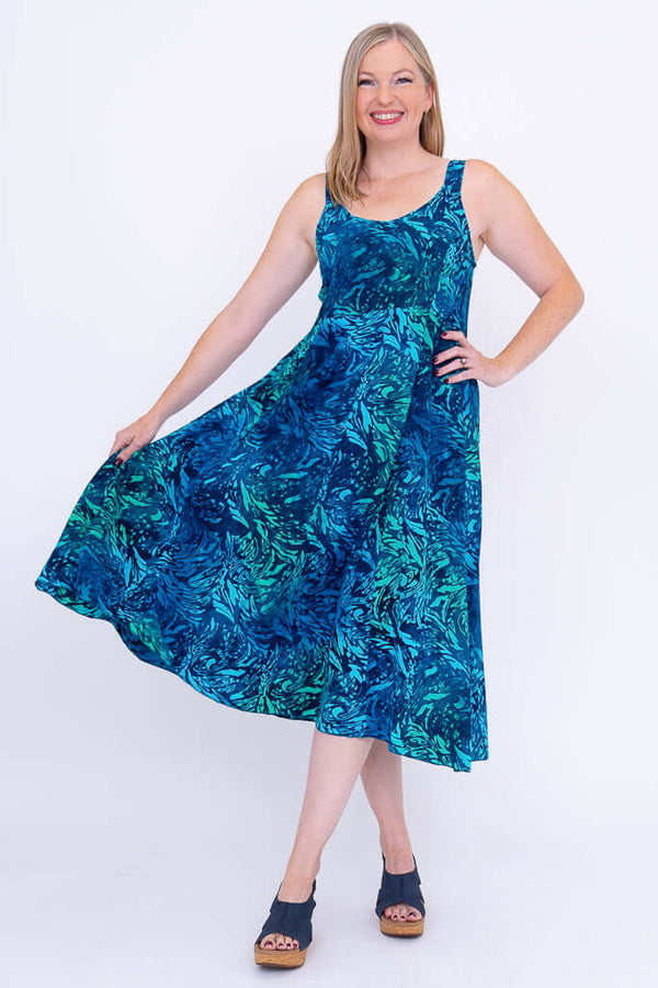 Woman twirling in Shauna blue A-line midi dress with pockets