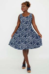 Woman twirling in a navy and white sleeveless A-line dress