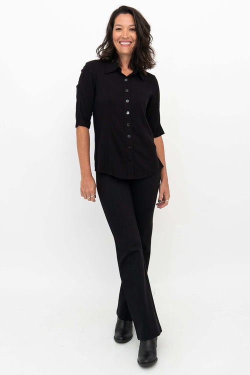 Woman wearing Daya Luxe Modal Pants in black with black button-up top