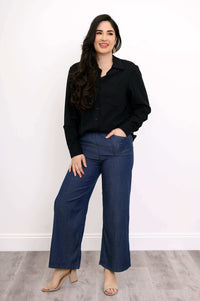 Woman wearing Parker wide leg tencel pants in denim with black shirt and sandals