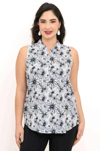Woman wearing a sleeveless white tank top with black floral print and quarter-zip detail