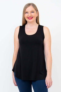 Woman wearing a black bamboo tank top with blue pants, front view, smiling