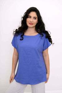 Woman modeling a blue linen blend tee with round neckline, looking to the side