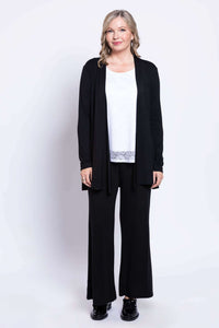 Woman wearing white lace tank top styled with a black open cardigan