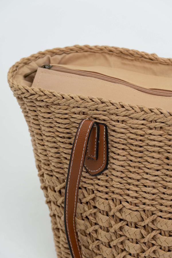 Close-up of tote bag top showing beige lining and zipper closure