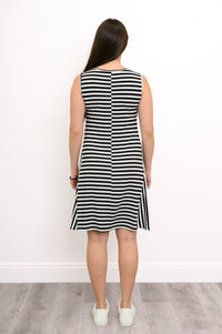 Back view of a woman wearing a sleeveless black and white striped bamboo dress with a round neckline and knee-length hem.