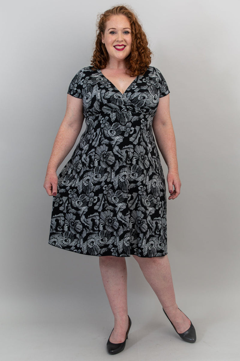 A black-and-white v-neck dress made with natural bamboo fibre featured on a plus-size model.