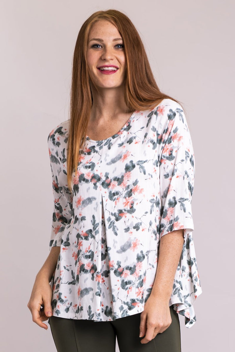 Women's coral wisp print 3/4 sleeve front pleated shirt with round neckline.