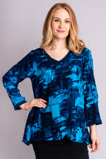 Women's blue long-sleeve loose fitting blouse with V-neck.