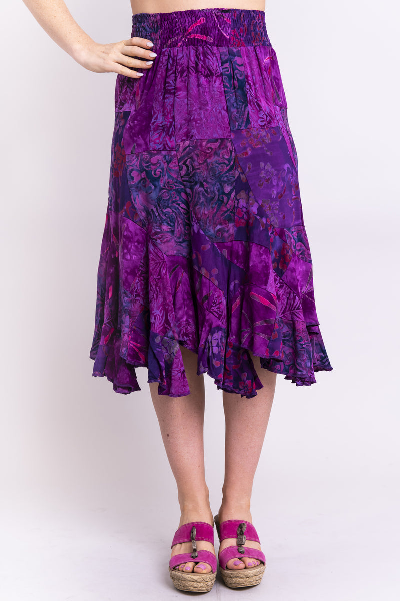 Women's purple batik art knee-length flowy patchwork ruffle skirt, with wide elastic waistband.