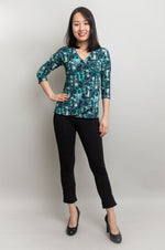 A model wearing a v-neck 3/4 sleeve top in teal colour made with natural Bamboo fabric.