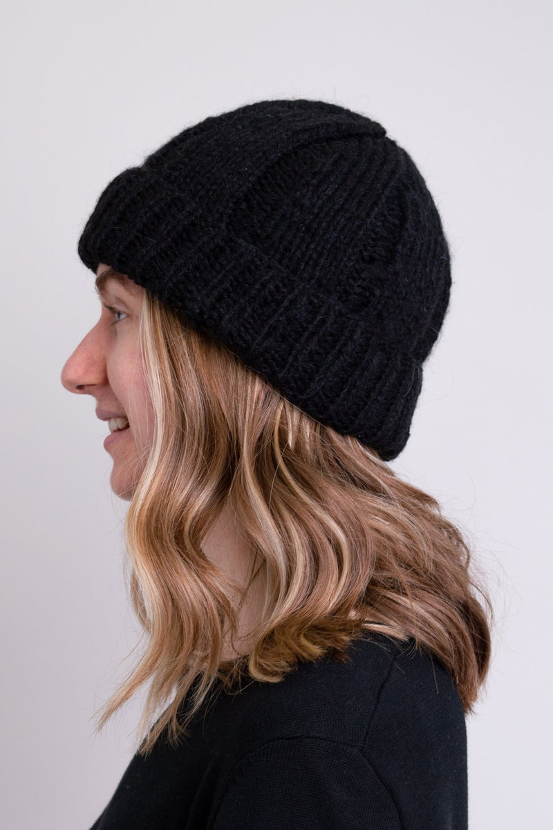 Women's black knit toque wool beanie hat.