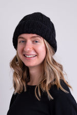 Women's black knit toque wool beanie hat.